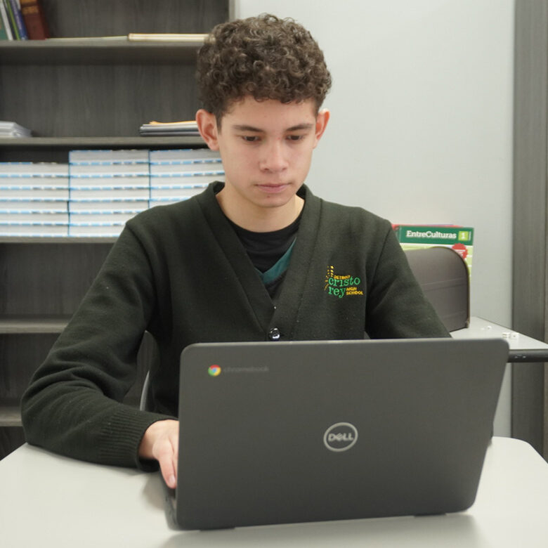 DCR student on laptop two classmates at Detroit Cristo Rey