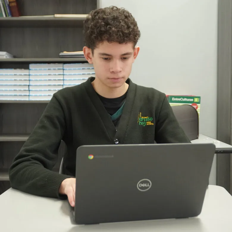 DCR student on laptop two classmates at Detroit Cristo Rey